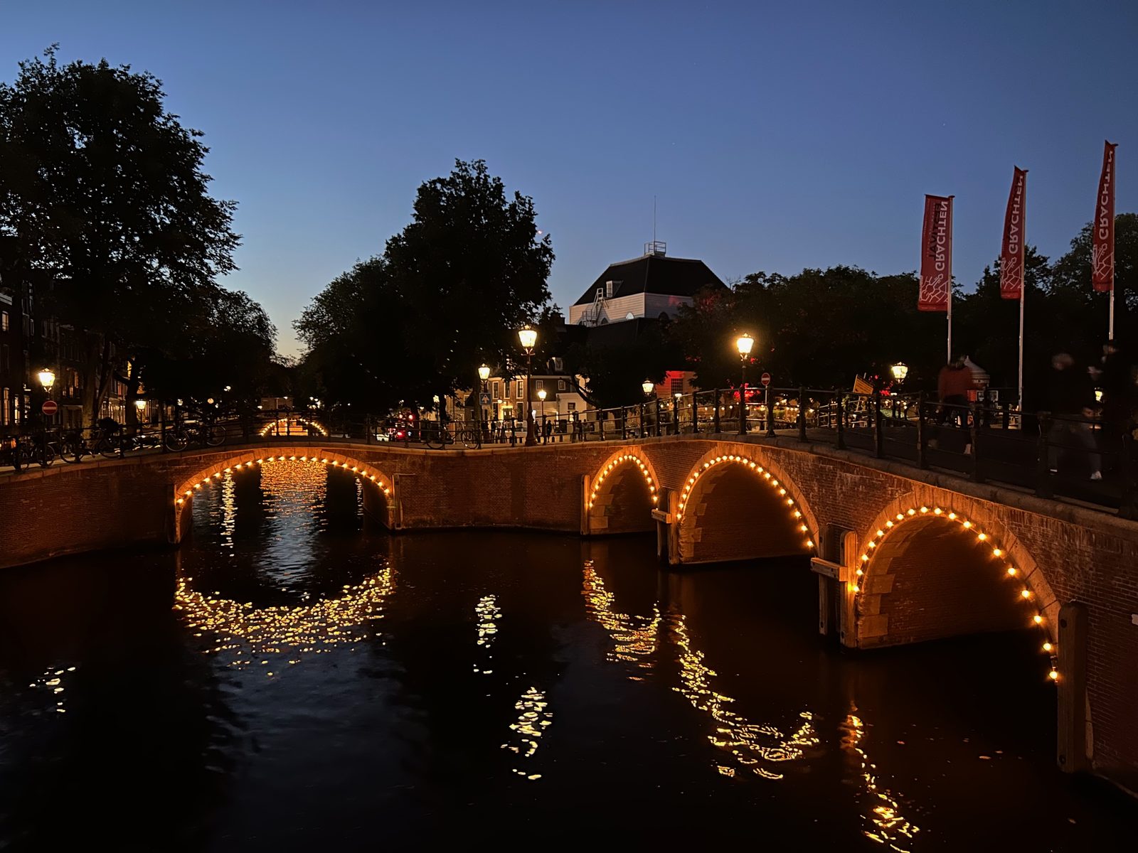 Amsterdam canal bridge lit up at night